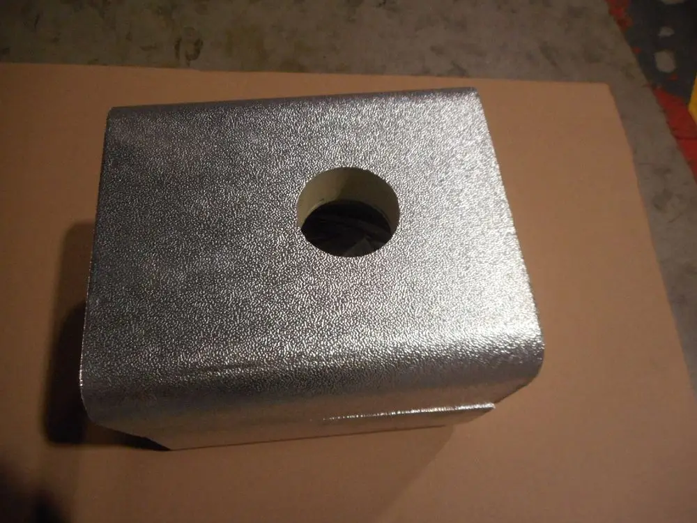 Silberne Isolierbox mit runder Öffnung, eventuell zur Verwendung mit Remeha Produkten, auf einer neutralen Unterlage.
